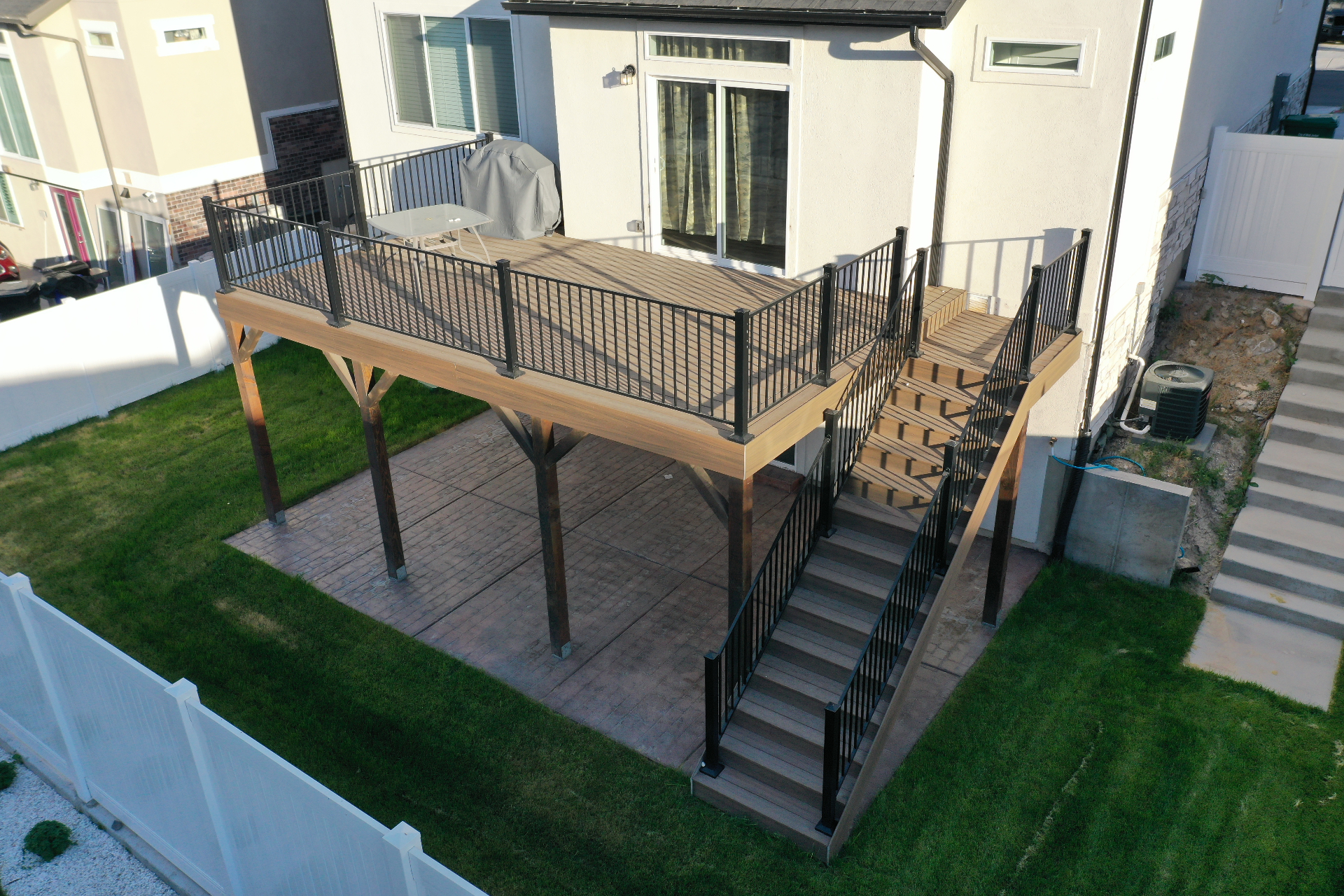 Multi-tone composite deck with staircase and open patio below