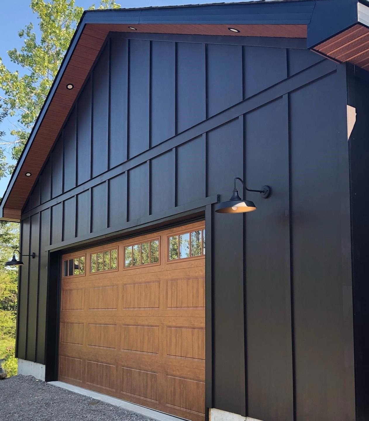 Board and batten carriage house with wood accents