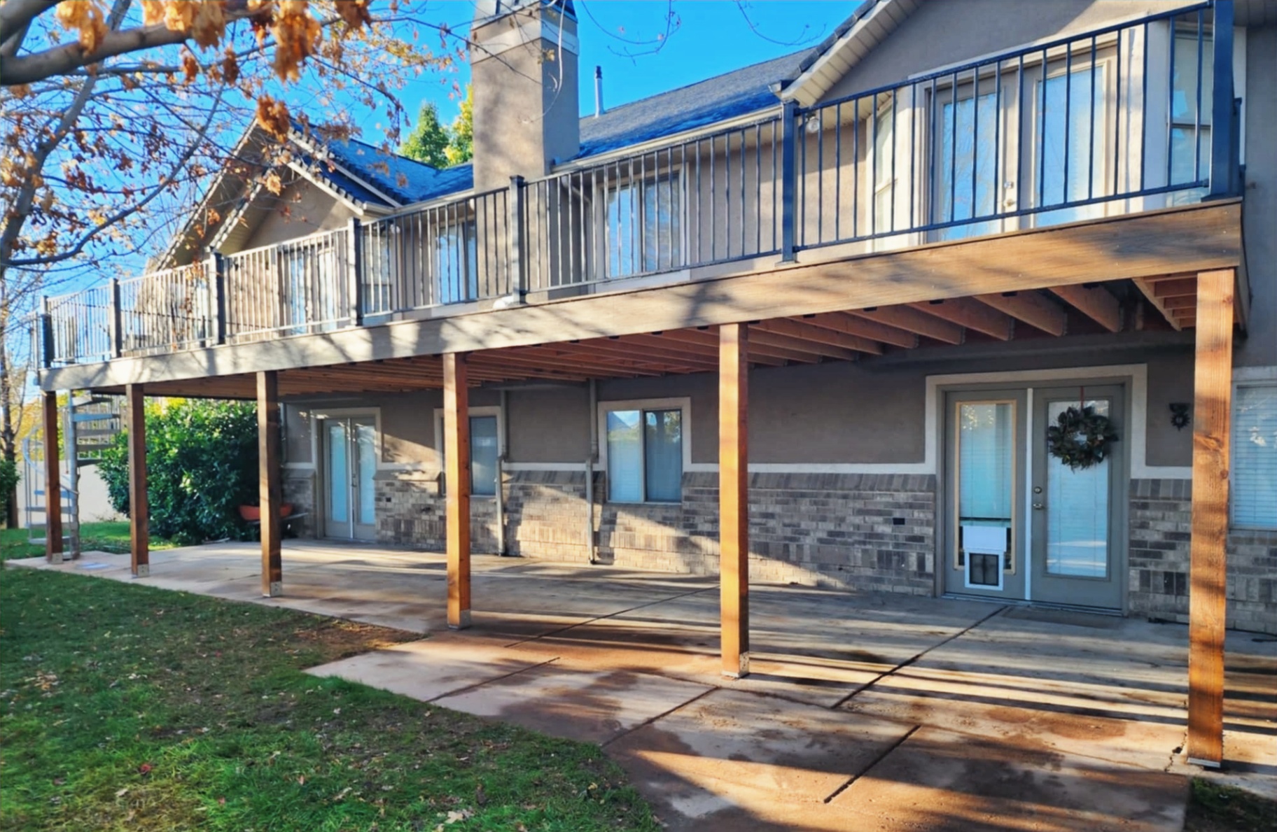 Elevated stained timber deck with brick column base